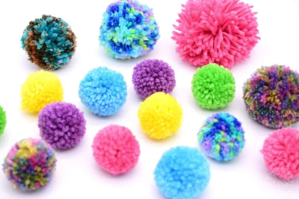 different colored yarn pom poms of different sizes