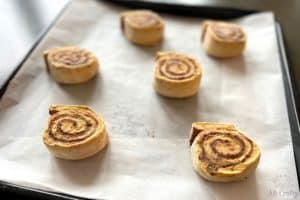 6 frozen cinnamon rolls on a baking sheet