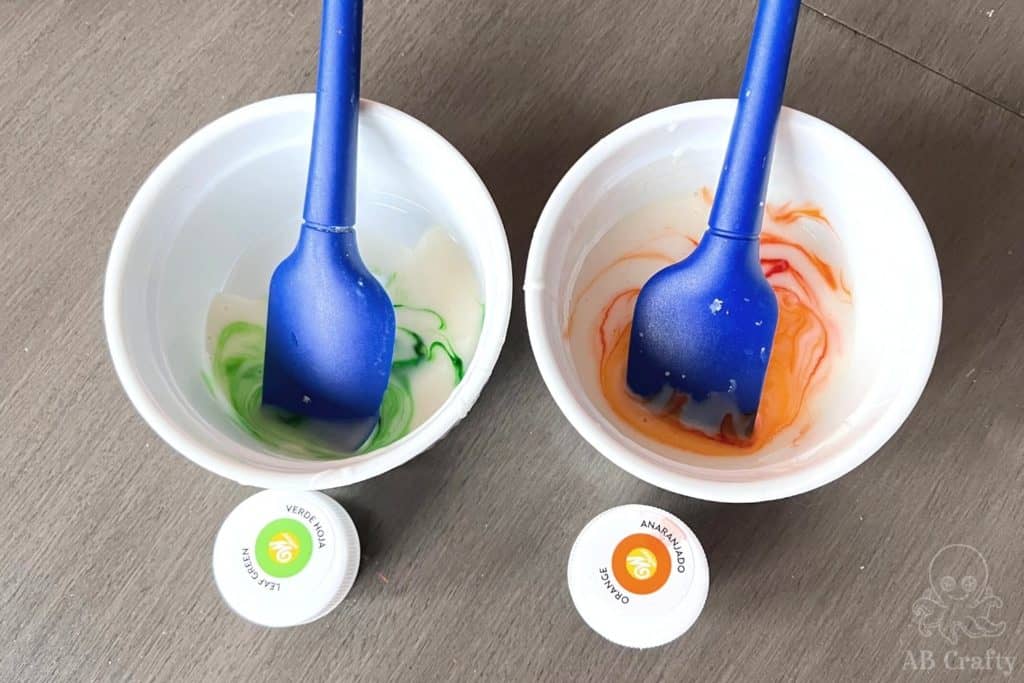 bowls with frosting and orange and green food coloring