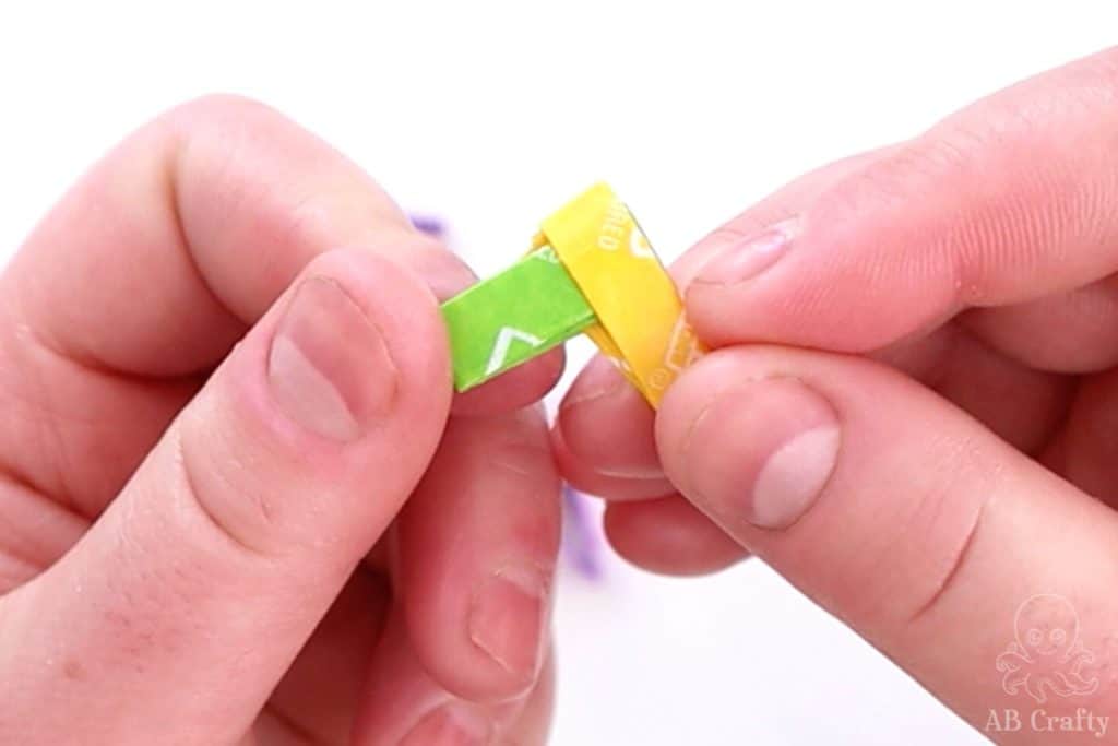 yellow and green candy wrappers starting to form a chain