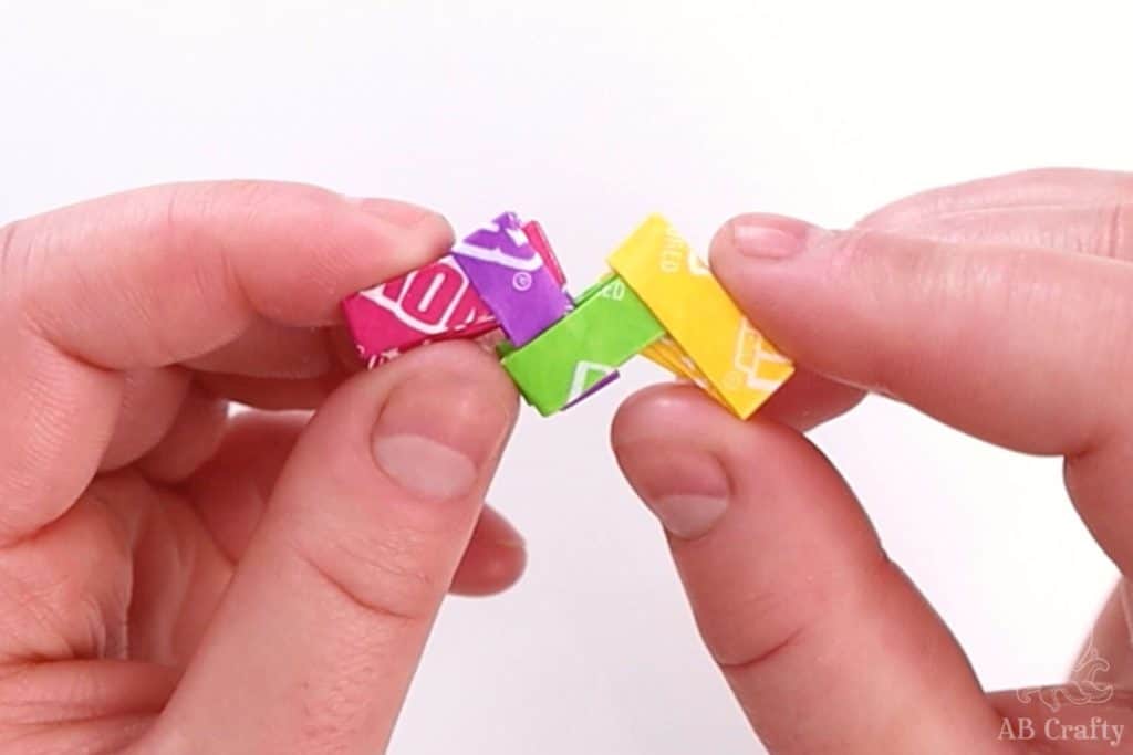 beginning of a gum wrapper chain made with different colors of now and later candy wrappers