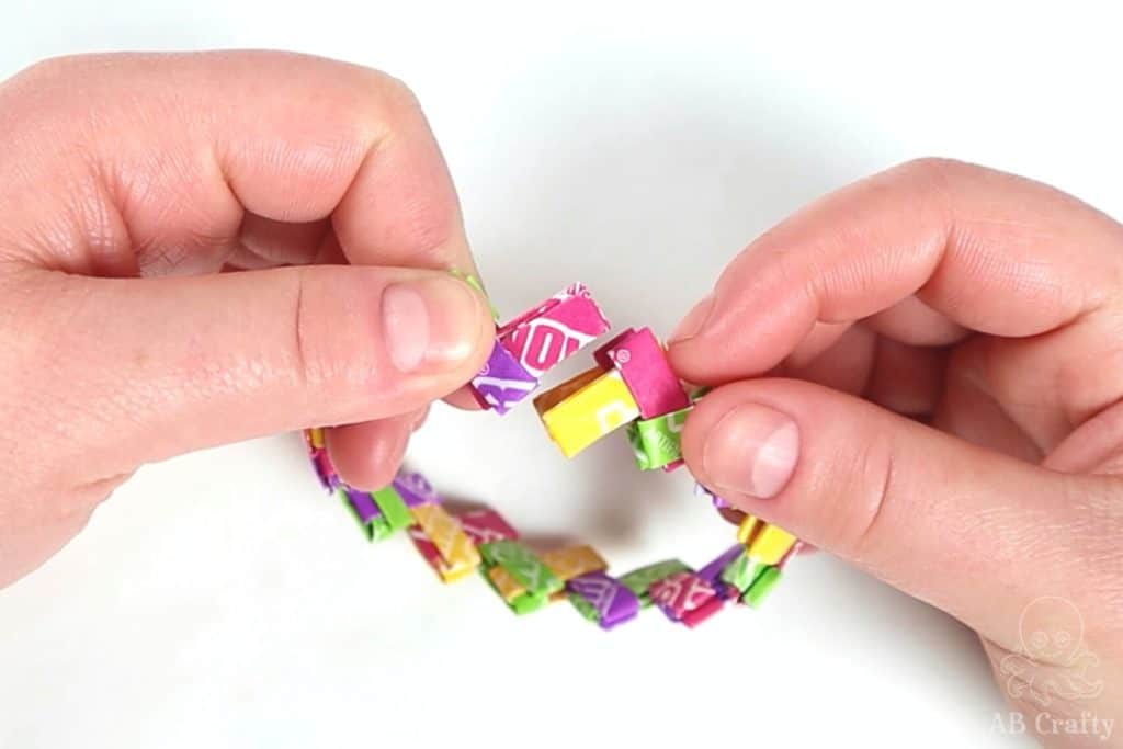 folding over the candy wrapper chain to check the ends