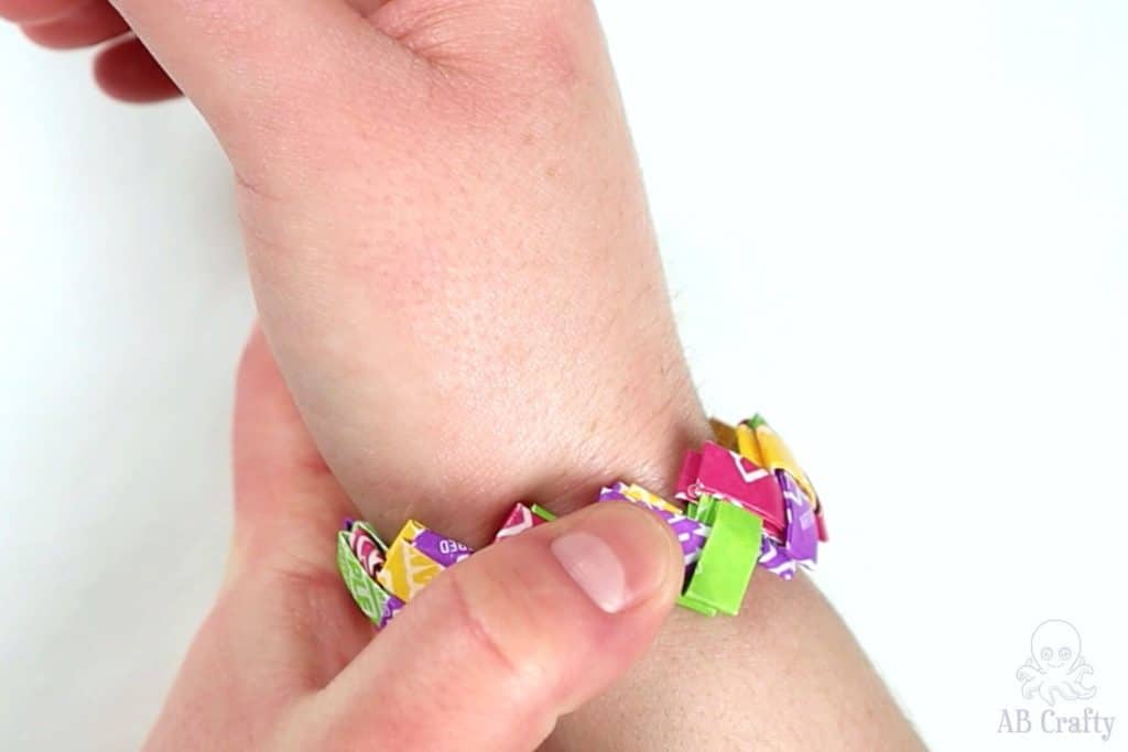 squeezing the starburst wrapper bracelet to make it smaller