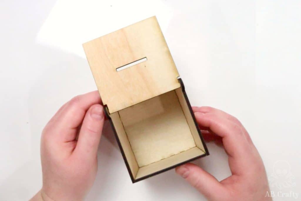 showing the open laser cut coin box