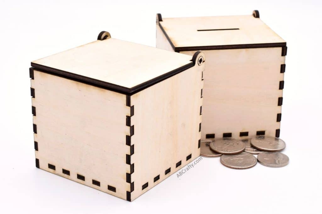 closed laser cut box and laser cut coin box with coins in front