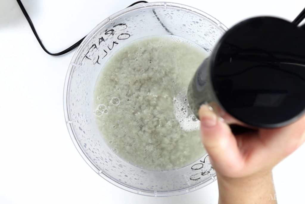 using a hand blender to blend paper and water into pulp