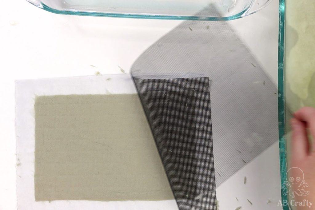 peeling back the mesh off the paper