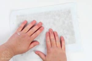 using hands to press the cloth to get water out