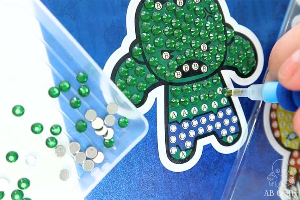 adding a green diamond to a hulk diamond painting sticker kit