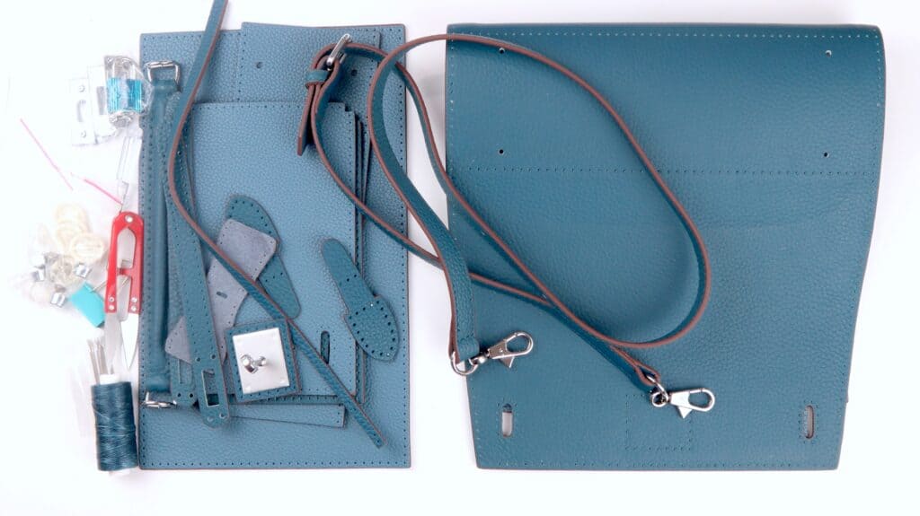 medium peacock babylon leather kelly bag components laid out