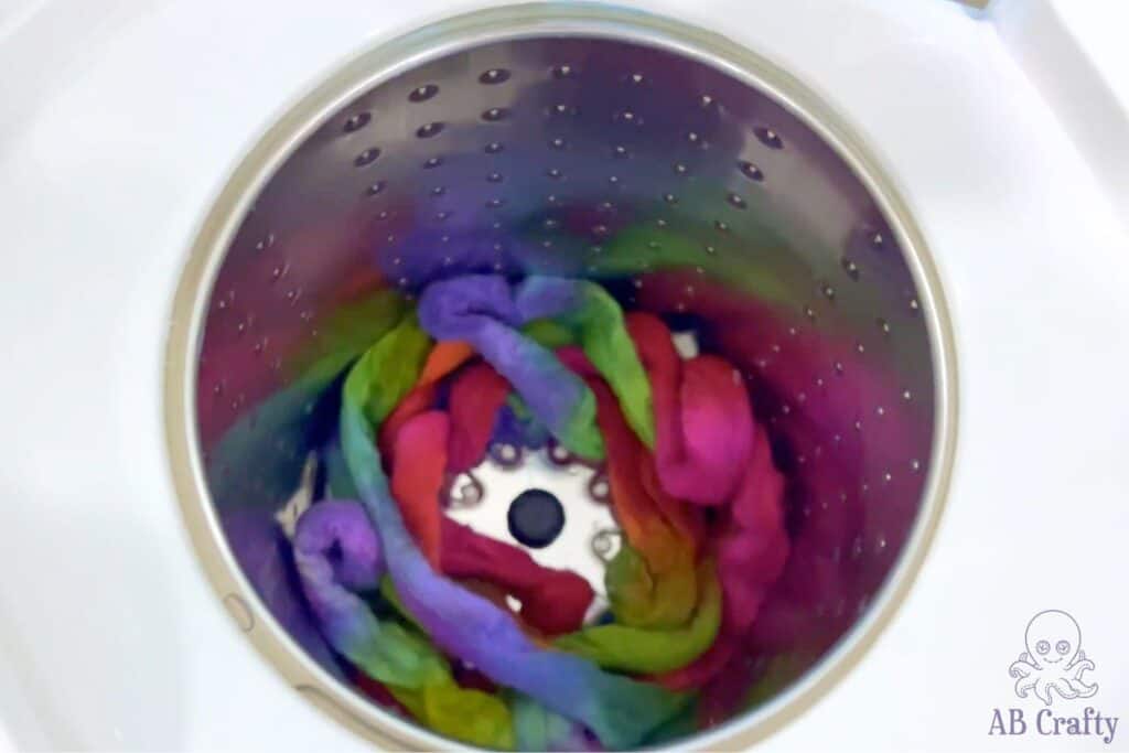 rainbow dyed wool in the bottom of a laundry spin dryer