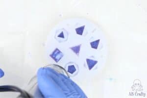 using a heat gun on silicone dice mold with purple resin