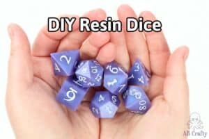 holding a set of purple resin dice with white numbers and the title "diy resin dice"