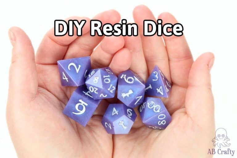 holding a set of purple resin dice with white numbers and the title "diy resin dice"