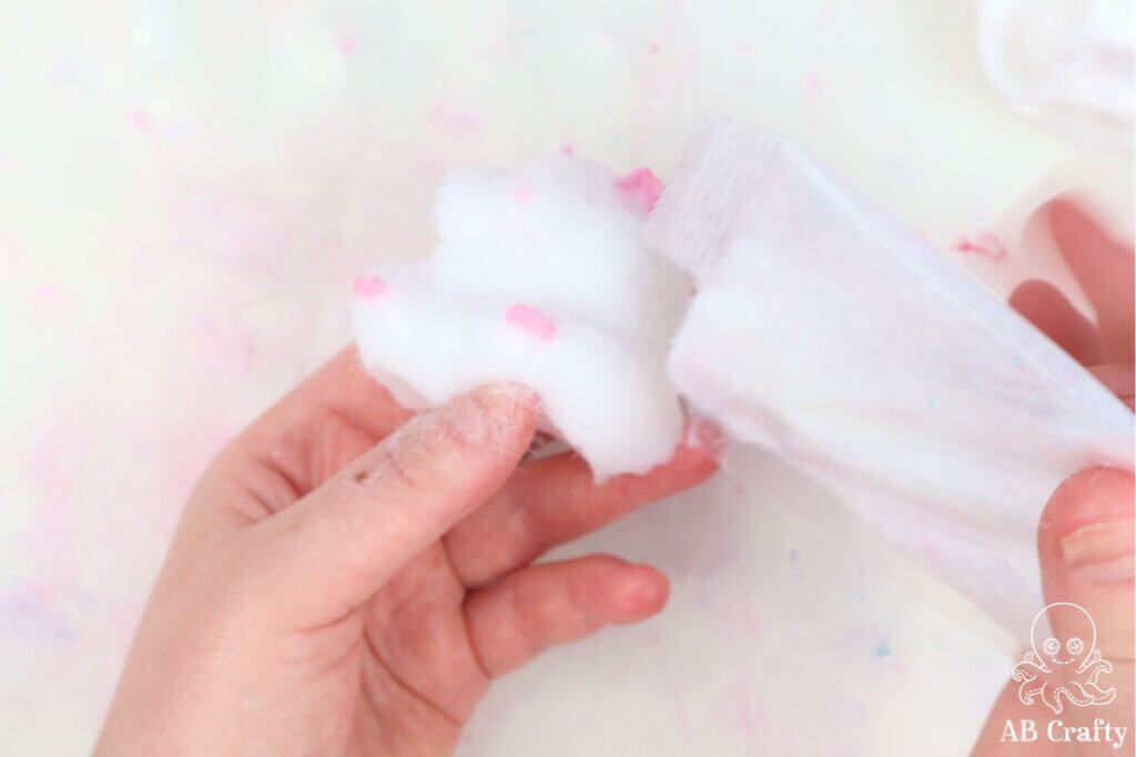 pouring white flocking powder on a DIY taba squishy hamster