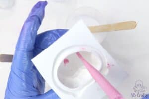 using a pipette to insert pink silicone into a taba suishy hamster mold