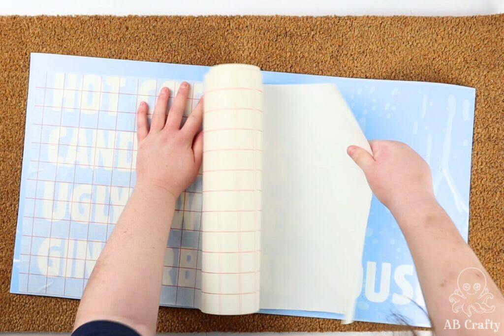 placing stencil transfer paper over the vinyl stencil