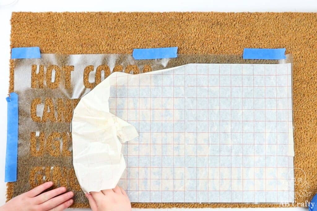 peeling back the stencil transfer paper